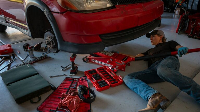 a man working on a car in a garage